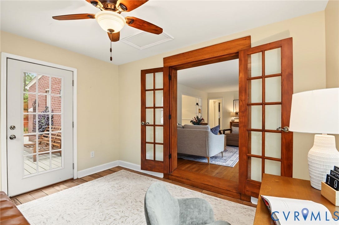 3353 Warner Road, Stratford Hills, Richmond, VA 23225 Wood-finish flooring, ceiling fan with integrated lighting, glass-paneled exterior door, and double French doors with wood trim