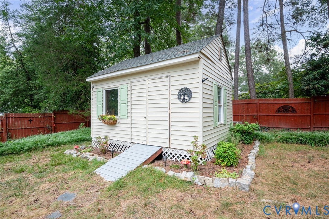 3353 Warner Road, Stratford Hills, Richmond, VA 23225 Detached outbuilding with light-colored siding, a green shingle roof, a window with green shutters, and a wood access ramp
