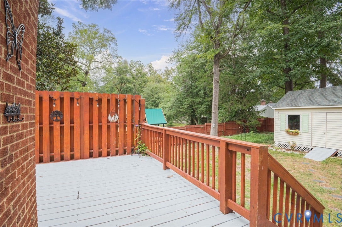 3353 Warner Road, Stratford Hills, Richmond, VA 23225 Deck with wood railing and privacy fence, featuring a brick exterior wall and a detached shed with light-colored siding