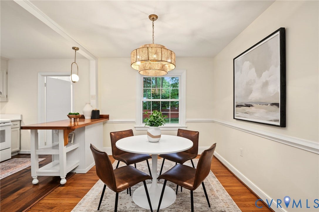 3353 Warner Road, Stratford Hills, Richmond, VA 23225 Hardwood flooring throughout, a multi-tiered chandelier, a built-in breakfast bar, and a window for natural illumination