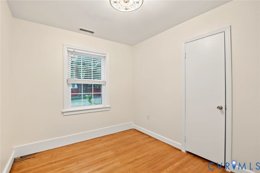 3353 Warner Road, Stratford Hills, Richmond, VA 23225 Light-toned walls, wood-finish flooring, white trim, and a flush mount ceiling light fixture