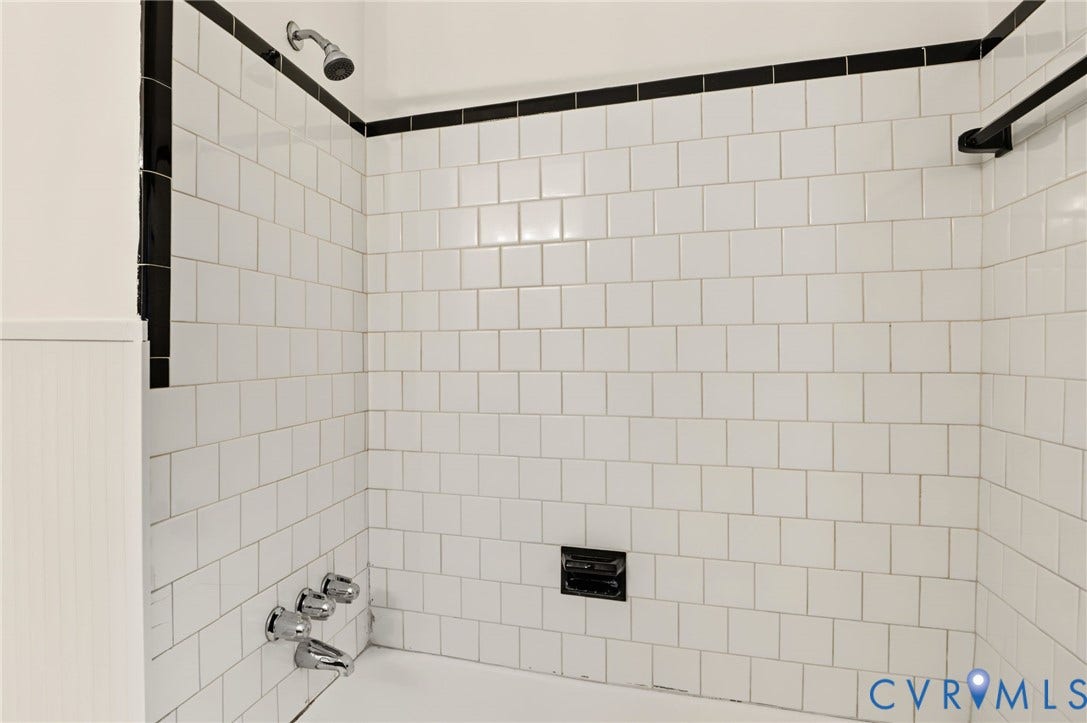 3353 Warner Road, Stratford Hills, Richmond, VA 23225 White subway tile shower surround with black accent trim and chrome fixtures