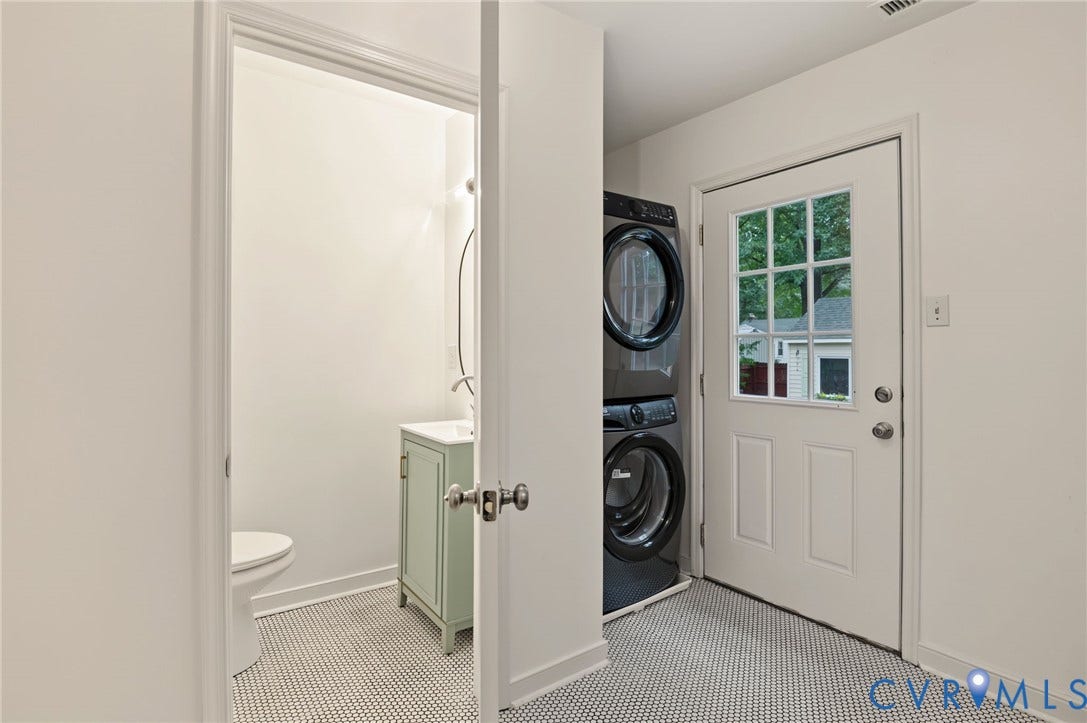 3353 Warner Road, Stratford Hills, Richmond, VA 23225 Laundry area with stacked appliances, white paneled door with windowpanes, and tile flooring