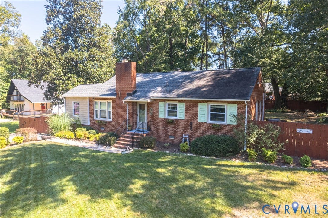 3353 Warner Road, Stratford Hills, Richmond, VA 23225 Brick exterior with shutters, a gabled roof, and a mature tree line