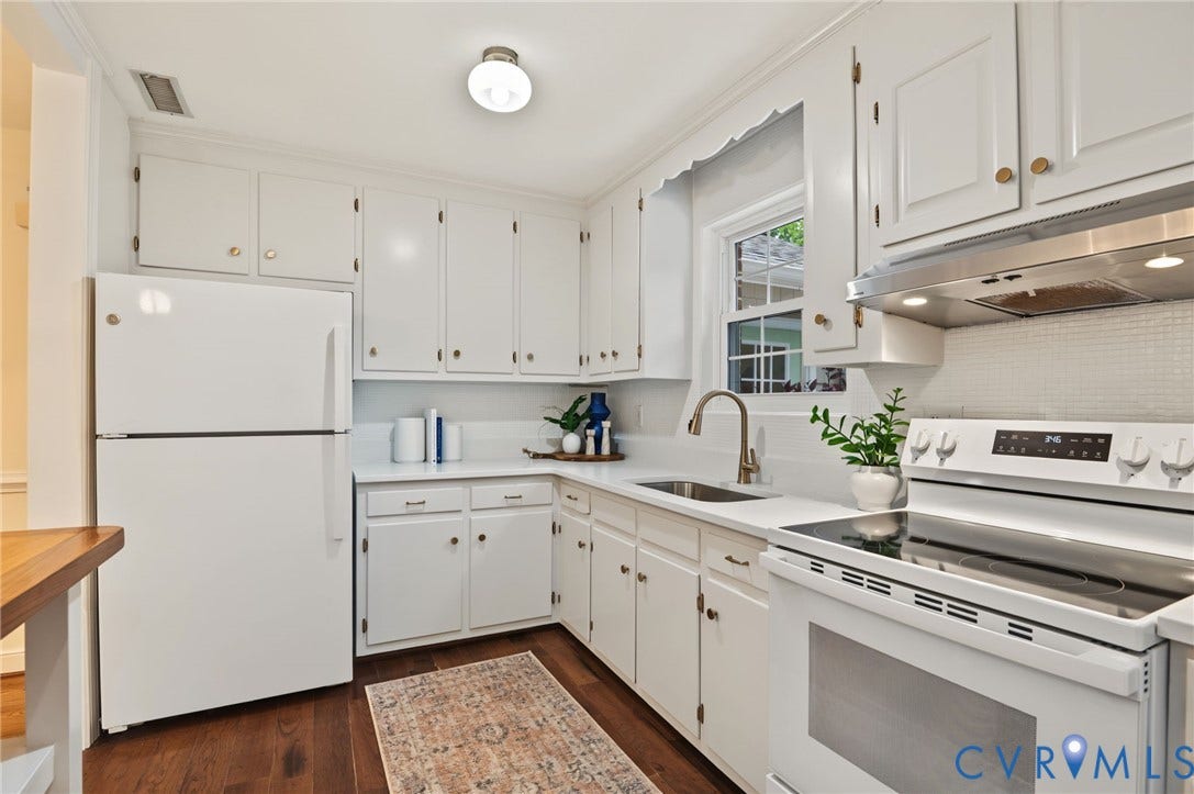 3353 Warner Road, Stratford Hills, Richmond, VA 23225 White cabinetry with gold-tone hardware, white countertops, built-in stainless steel range hood, stainless steel sink with gooseneck faucet, and wood-finish flooring