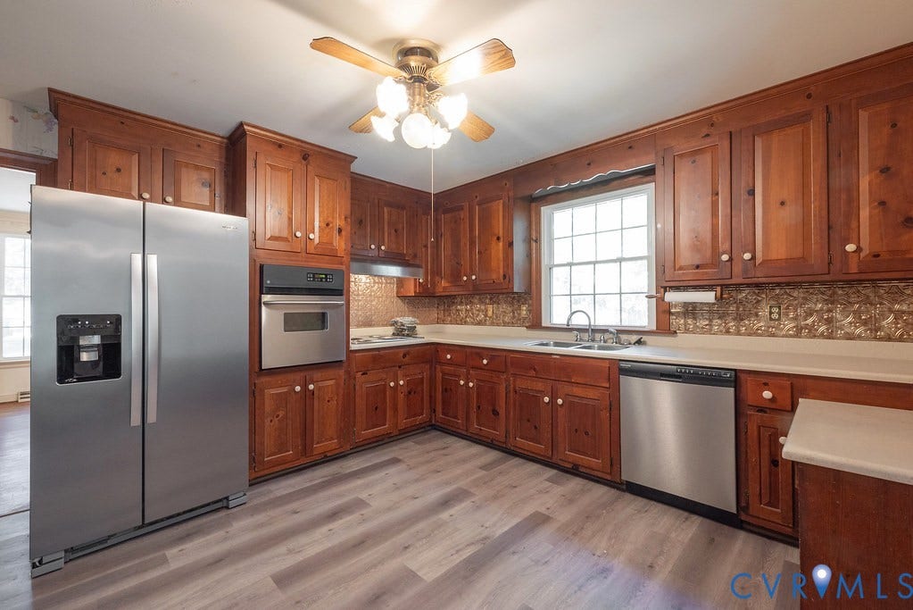 13830 Hailsham Circle, Salisbury, Midlothian, VA 23113 Wood cabinetry, stainless steel appliances, light-toned countertops, and wood-finish flooring