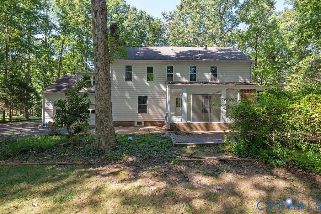 13830 Hailsham Circle, Salisbury, Midlothian, VA 23113 Two-story home with a multi-pane glass sliding door, an attached garage, and surrounding mature trees