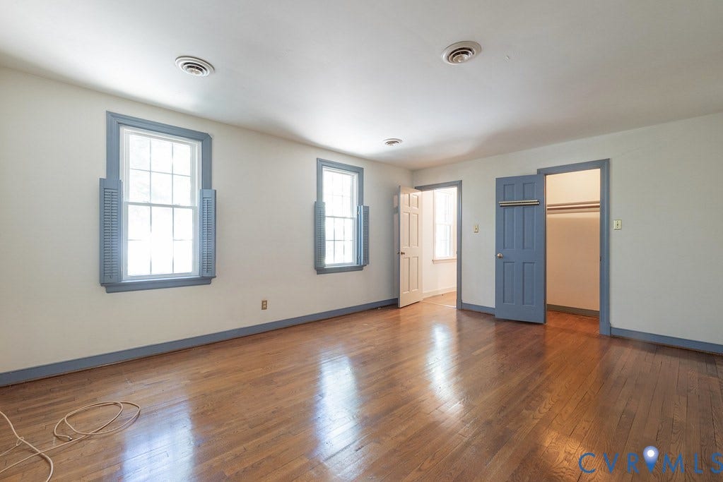 13830 Hailsham Circle, Salisbury, Midlothian, VA 23113 Hardwood-finish flooring, two large windows with shutters, two interior doorways, and an open closet with hanging rods