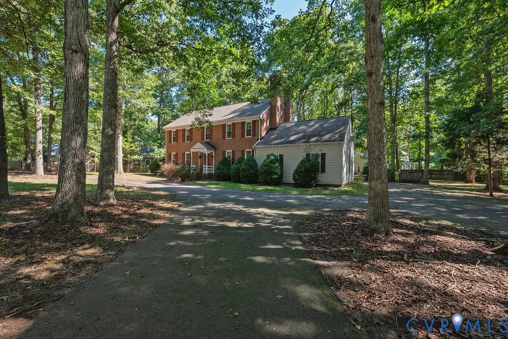 13830 Hailsham Circle, Salisbury, Midlothian, VA 23113 Traditional brick residence featuring a portico entry, white siding accent, and red window shutters