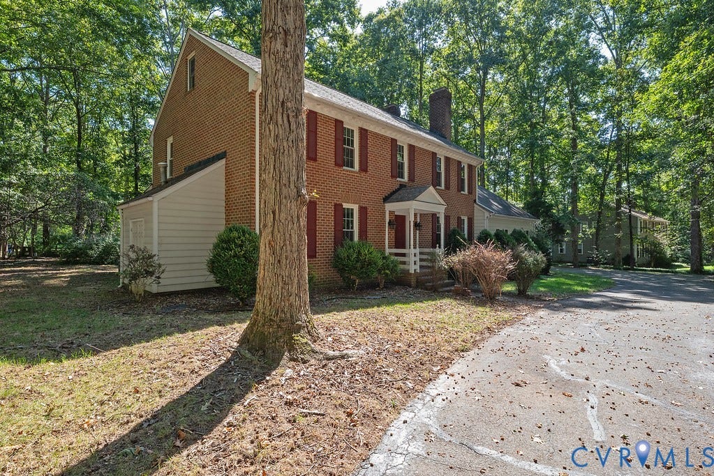 13830 Hailsham Circle, Salisbury, Midlothian, VA 23113 Brick exterior with red shutters, covered entry porch, and attached storage shed