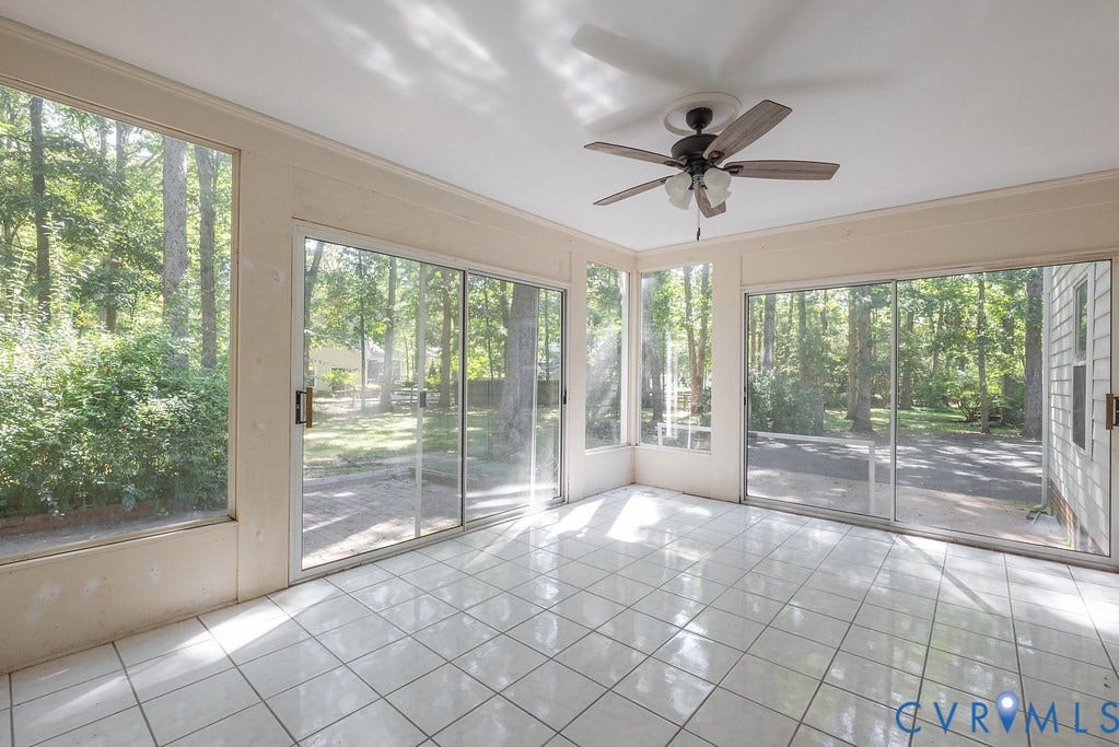 13830 Hailsham Circle, Salisbury, Midlothian, VA 23113 Expansive sunroom featuring multiple sliding glass doors, large fixed windows, tiled flooring, and an overhead ceiling fan with integrated lighting