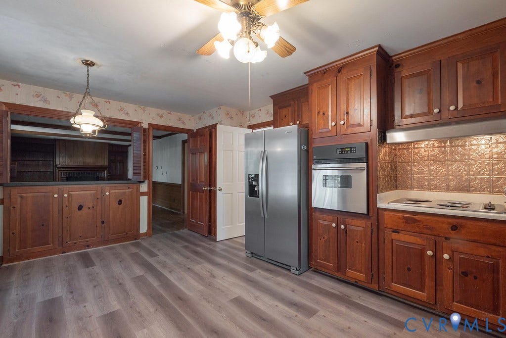 13830 Hailsham Circle, Salisbury, Midlothian, VA 23113 Wood-finish flooring, wood cabinetry, stainless steel appliances, built-in oven, and a decorative backsplash