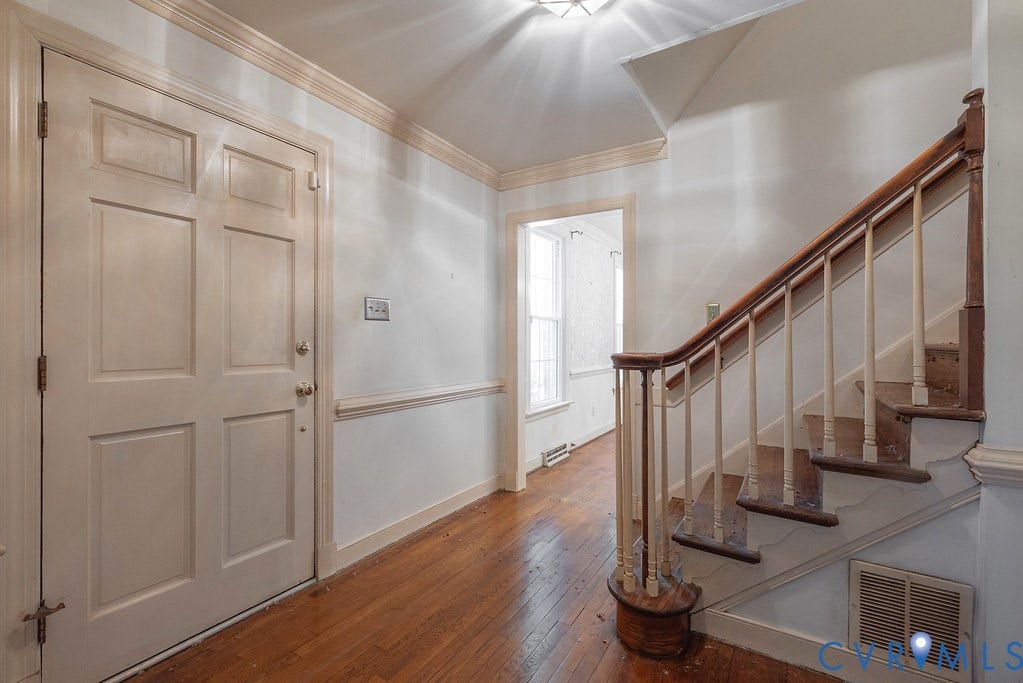 13830 Hailsham Circle, Salisbury, Midlothian, VA 23113 Entryway featuring wood-finish flooring, a paneled door, and a staircase with a wood handrail