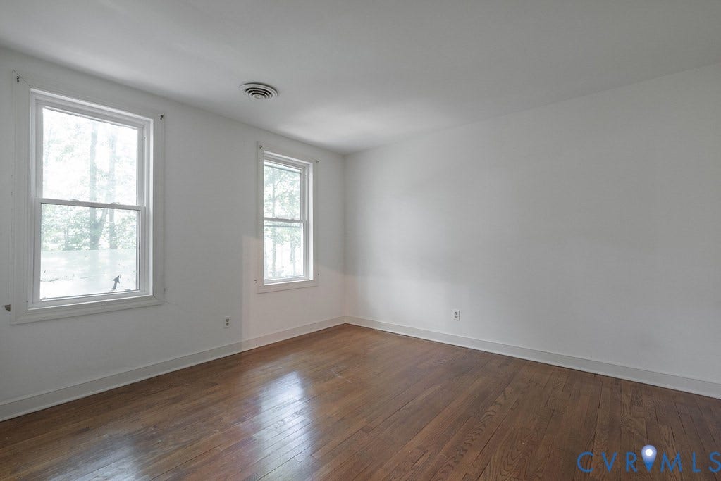 13830 Hailsham Circle, Salisbury, Midlothian, VA 23113 Hardwood flooring, two single-hung windows with white trim, white walls, and a ceiling-mounted circular vent