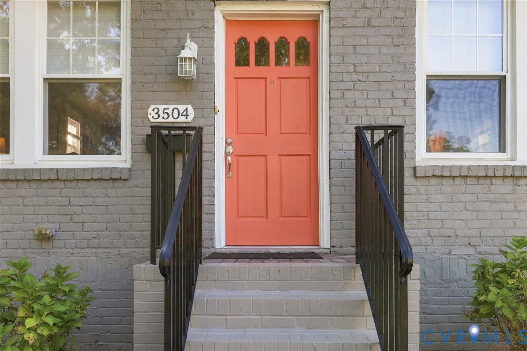 3504 Delaware Avenue, Richmond, VA 23222 Brick exterior with a vibrant coral entry door, complemented by white trim windows