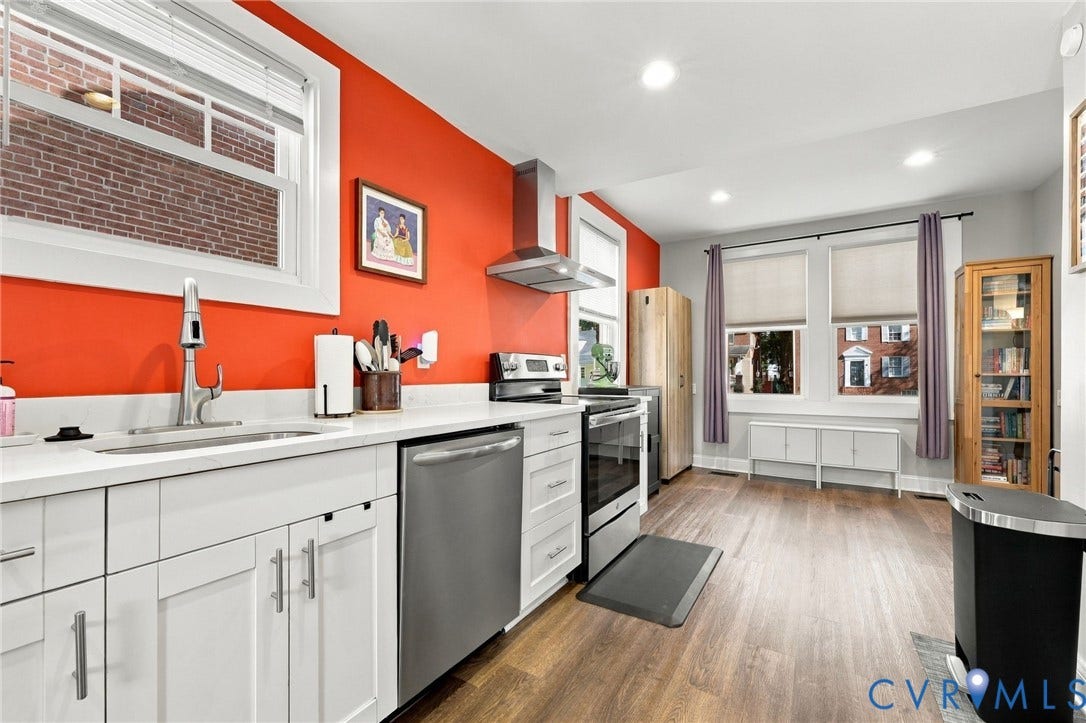 3504 Delaware Avenue, Richmond, VA 23222 White cabinetry with modern hardware, stainless steel appliances, wood-finish flooring, recessed lighting, and a contemporary range hood