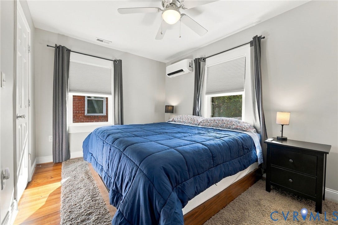 3504 Delaware Avenue, Richmond, VA 23222 Hardwood flooring, ceiling fan, white paneled door, window blinds, and split-system AC unit
