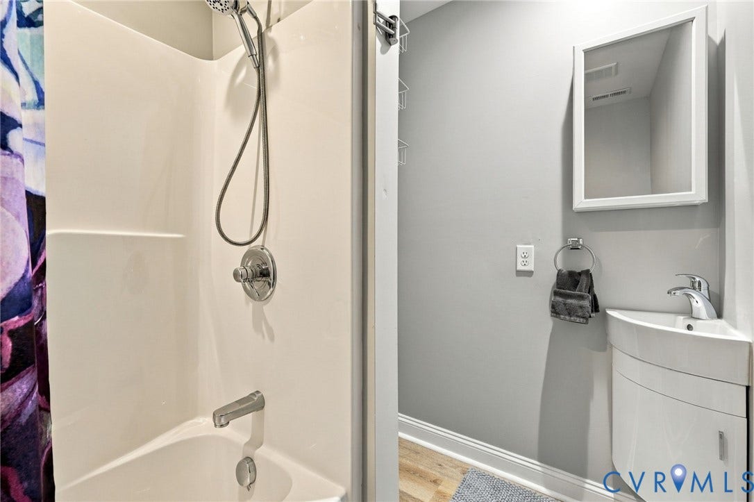 3504 Delaware Avenue, Richmond, VA 23222 Integrated shower and tub unit with chrome fixtures