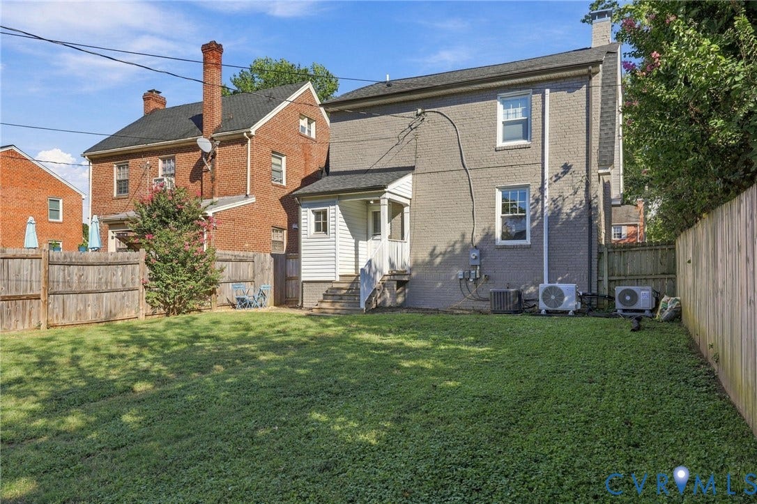 3504 Delaware Avenue, Richmond, VA 23222 Expansive grassy lawn with a wood privacy fence