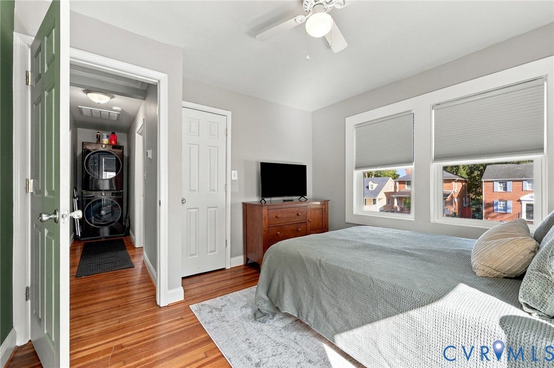 3504 Delaware Avenue, Richmond, VA 23222 Hardwood flooring, two windows with blinds, ceiling fan, and a stacked washer and dryer unit