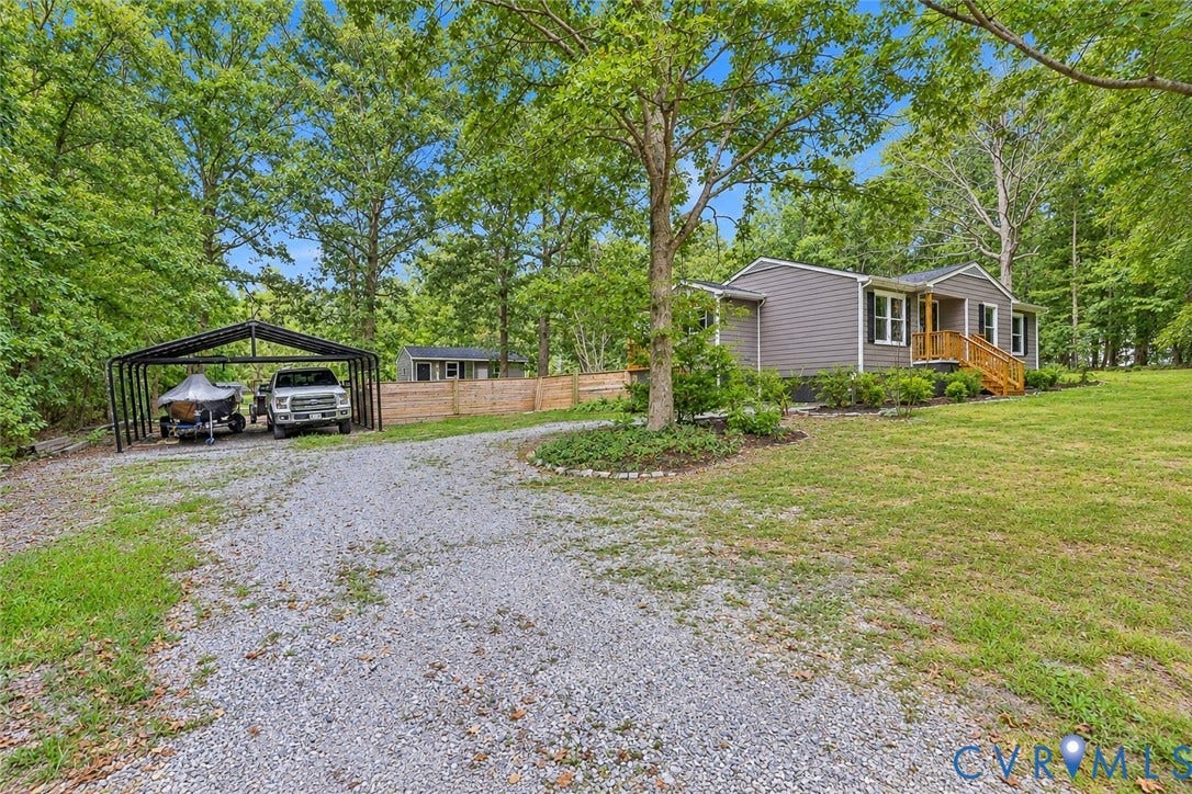 Gray siding exterior with black window shutters