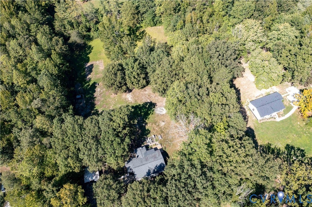 Expansive lot featuring mature trees and two residential structures