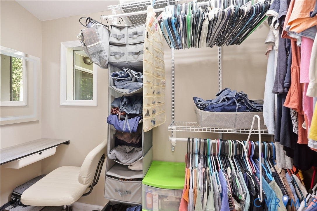 Built-in closet organization system with hanging rods and shelving