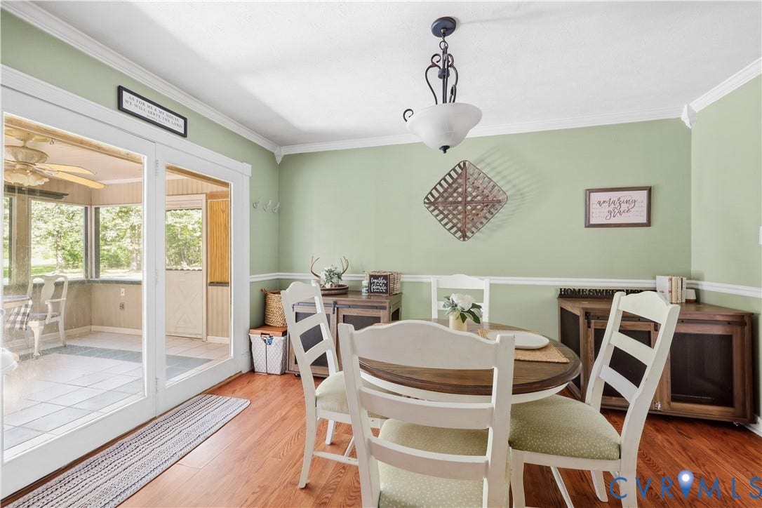 Wood-finish flooring, crown molding, and chair rail detailing