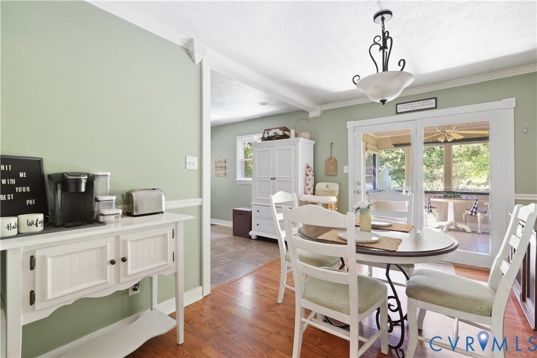 Hardwood-style flooring, white trim, recessed lighting, and a glass-paneled patio door