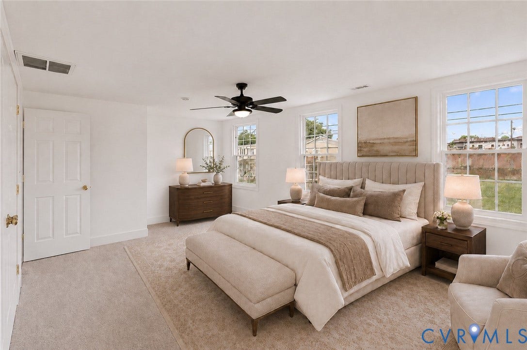 White interior walls, ceiling-mounted light fixture with fan, two multi-pane windows, and wall-to-wall carpeting