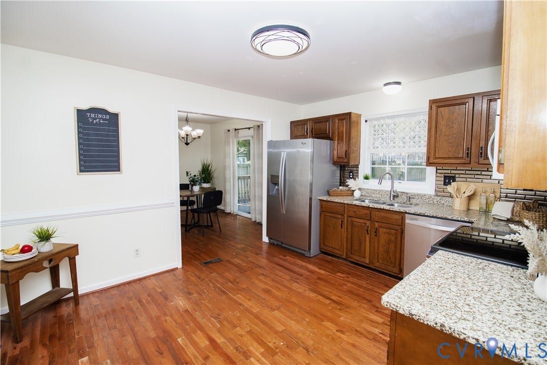 1307 Berrymeade Avenue, Henrico, VA 23060 Kitchen featuring wood-finish flooring, granite countertops, stainless steel appliances, and wood cabinetry