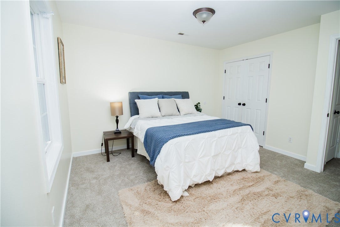 1307 Berrymeade Avenue, Henrico, VA 23060 Light-toned walls, gray carpeting, a window with white trim, and a white bi-fold closet door