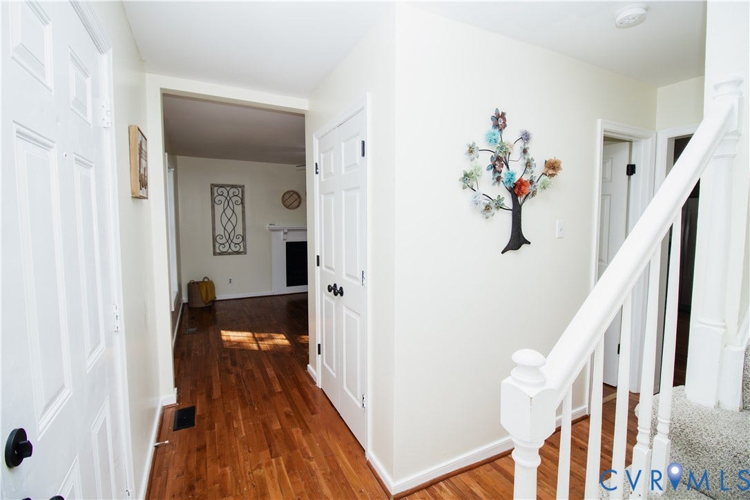 1307 Berrymeade Avenue, Henrico, VA 23060 Hardwood flooring, painted interior doors, white trim, white staircase newel post, and white staircase railing