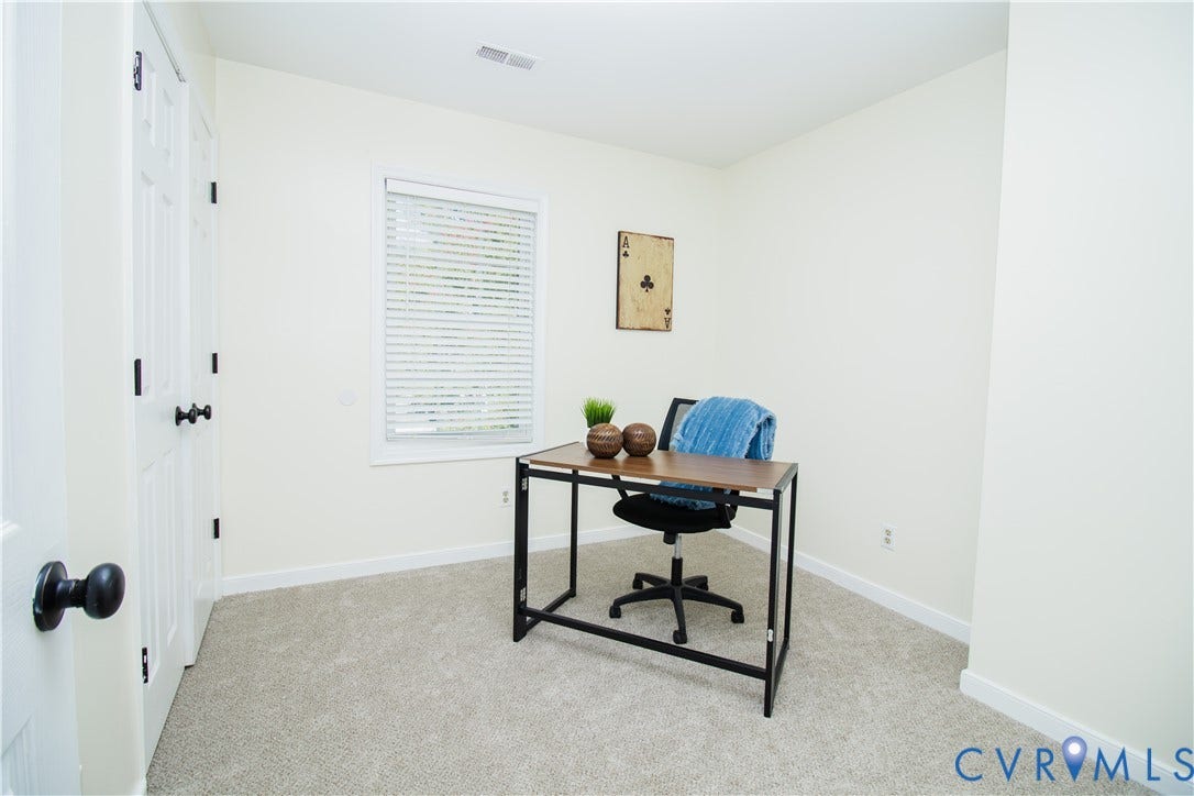 1307 Berrymeade Avenue, Henrico, VA 23060 Neutral wall tones, window with horizontal blinds, and paneled door with dark hardware
