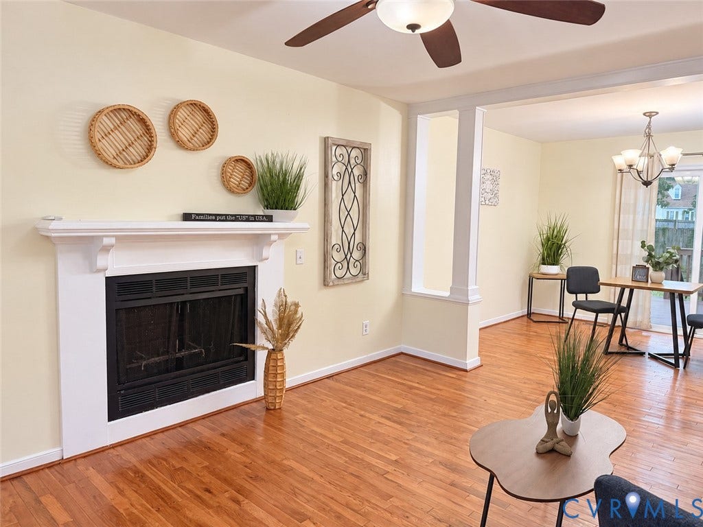 1307 Berrymeade Avenue, Henrico, VA 23060 Hardwood flooring throughout, a white mantel fireplace, ceiling fan with integrated lighting, and a columned entryway to an additional space