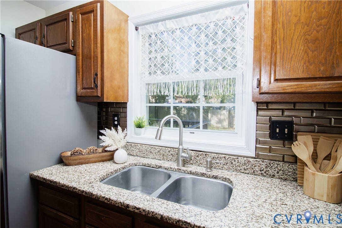 1307 Berrymeade Avenue, Henrico, VA 23060 Dual basin stainless steel sink with a high-arc faucet, set into a speckled countertop