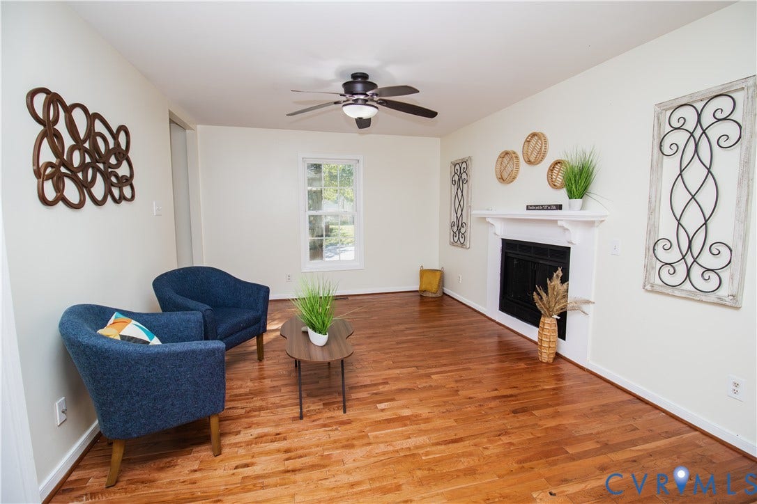 1307 Berrymeade Avenue, Henrico, VA 23060 Hardwood flooring, white fireplace, ceiling fan with light fixture, white walls, and a window providing natural light