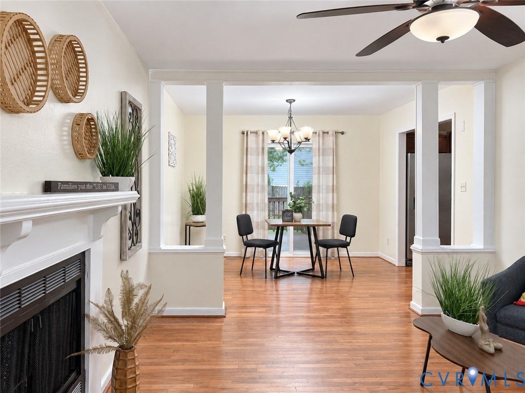 1307 Berrymeade Avenue, Henrico, VA 23060 Hardwood-finish flooring, white fireplace mantel, dining area with chandelier, ceiling fan, and architectural columns