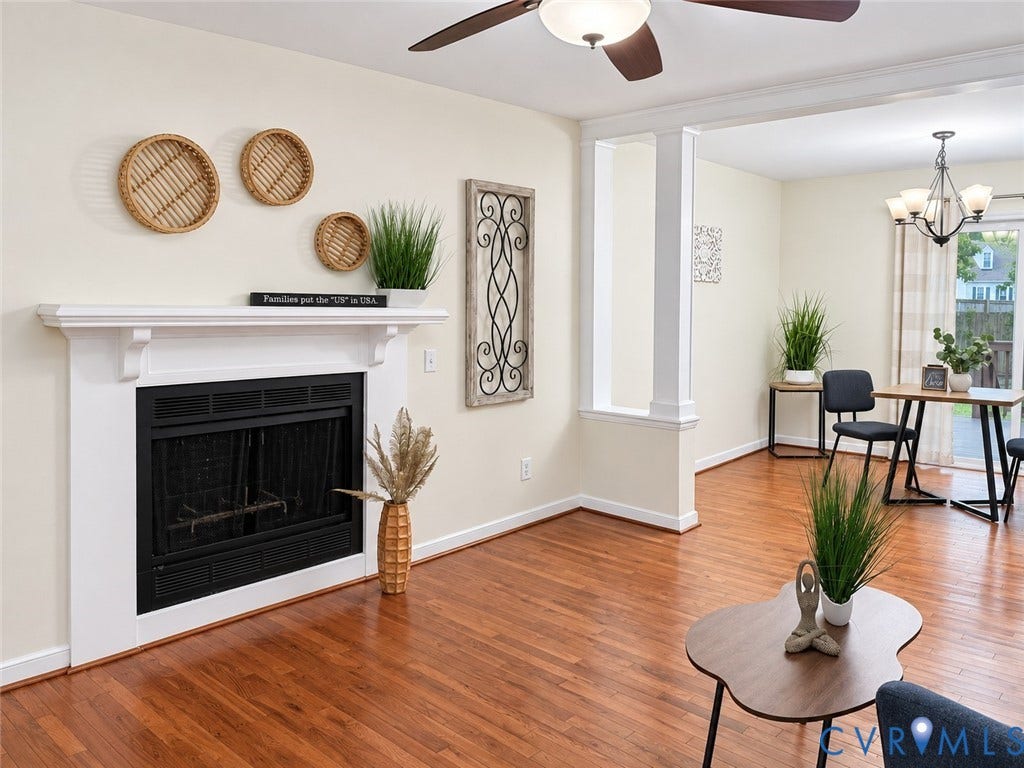 1307 Berrymeade Avenue, Henrico, VA 23060 Hardwood flooring, white mantel, fireplace, ceiling fan, and decorative columns