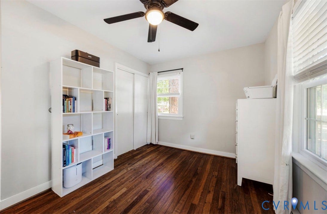 Hardwood flooring, ceiling fan with integrated lighting, sliding closet doors, and window with blinds