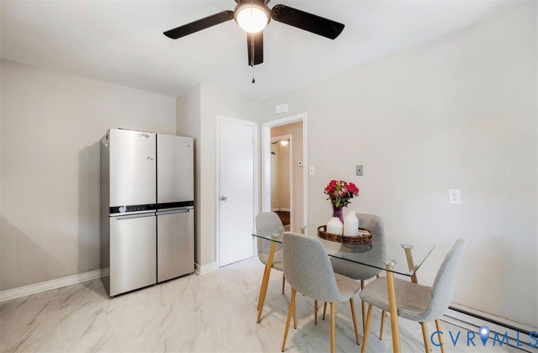 Stainless steel French-door refrigerator, ceiling fan with integrated lighting, and light-toned flooring