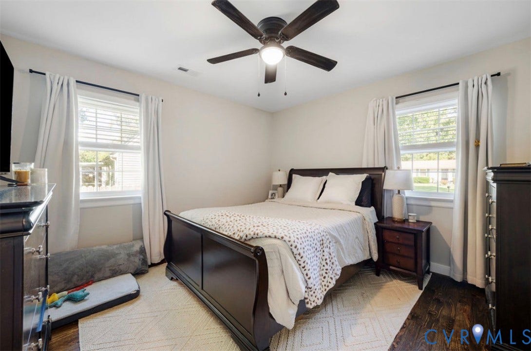 Hardwood flooring, two windows with blinds, ceiling fan with integrated lighting, recessed lighting, and light-toned wall finishes