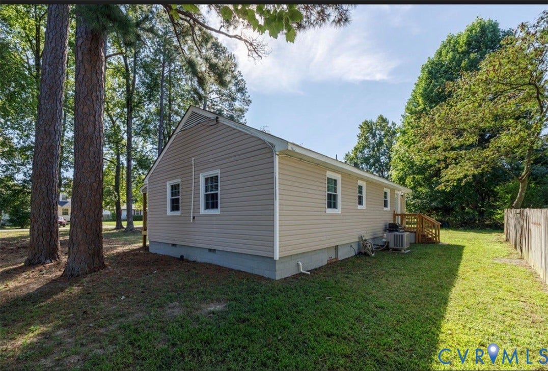 Tan siding exterior with white trim windows