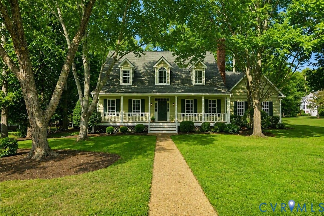 3600 Rivermist Terrace, Midlothian, VA 23113 Traditional-style residence with a covered front porch featuring white railings, multiple dormer windows, and a prominent brick chimney