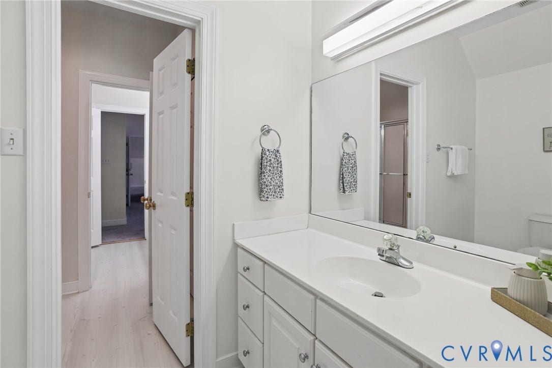 3600 Rivermist Terrace, Midlothian, VA 23113 Vanity with an integrated sink, polished chrome faucet, and expansive wall-mounted mirror