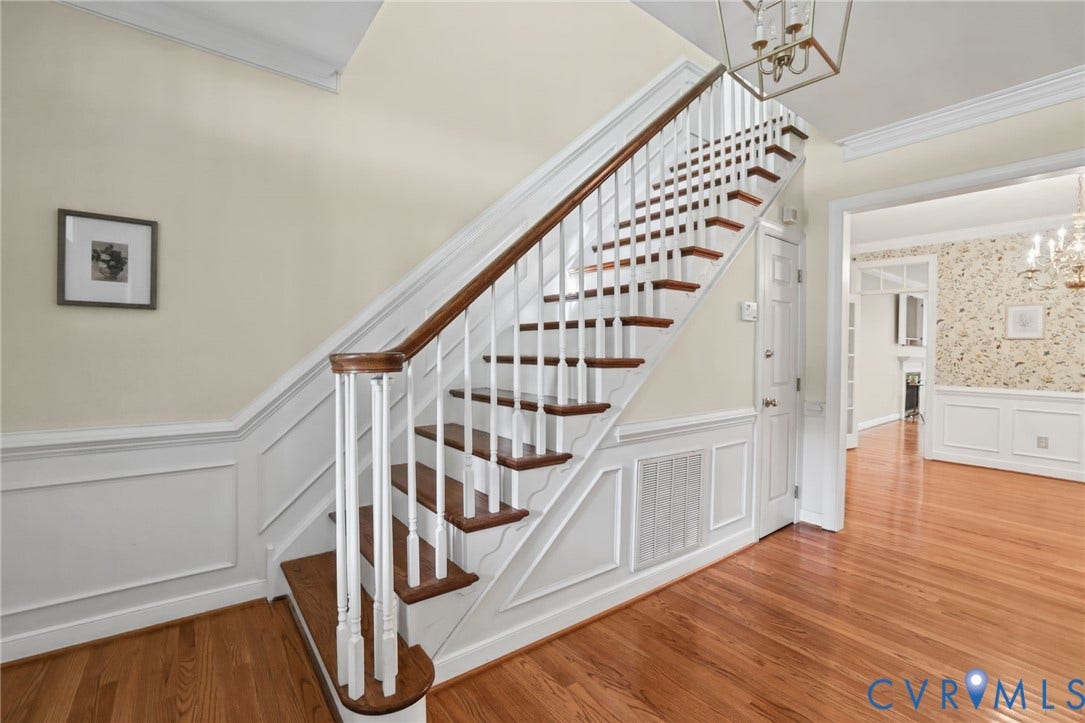 3600 Rivermist Terrace, Midlothian, VA 23113 Hardwood flooring, wainscoting, a traditional staircase with wood treads and white risers, crown molding, and a chandelier