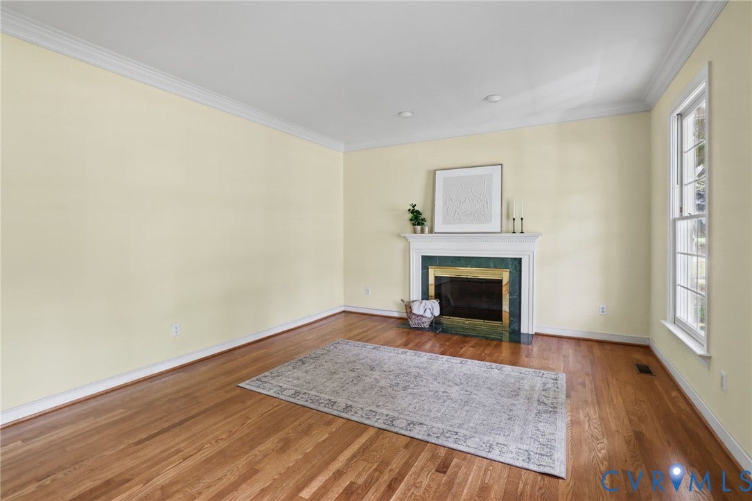 3600 Rivermist Terrace, Midlothian, VA 23113 Hardwood flooring, crown molding, fireplace with white mantel, green marble surround, and recessed lighting
