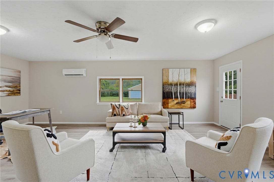 1814 Aeronca Avenue, Henrico, VA 23228 Wood-finish flooring, ceiling fan with integrated lighting, wall-mounted air conditioning unit, multiple windows, and a glass-paneled entry door