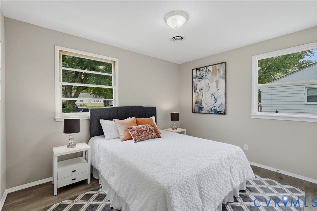1814 Aeronca Avenue, Henrico, VA 23228 Light gray walls, white trim, wood-finish flooring, two windows, and a ceiling-mounted light fixture