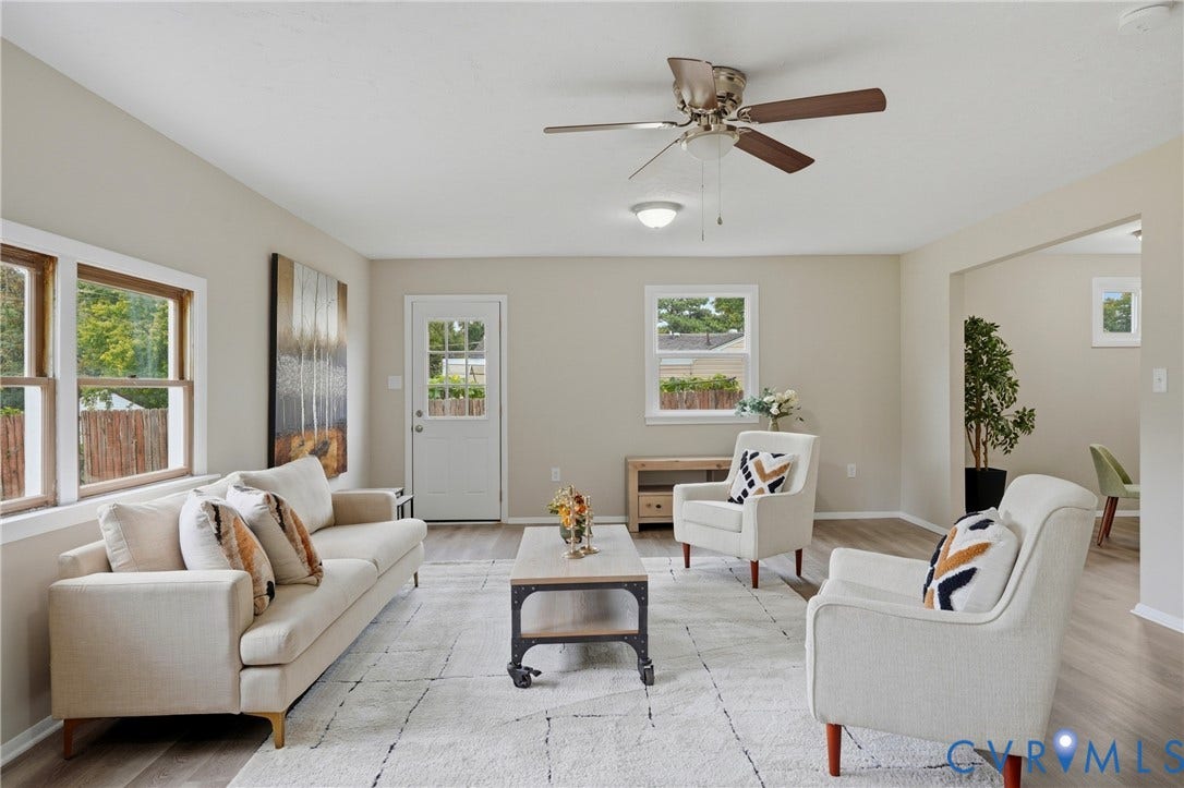 1814 Aeronca Avenue, Henrico, VA 23228 Vaulted ceiling with a ceiling fan, light wood-finish flooring, multiple windows, neutral wall tones, and an open doorway to an additional room